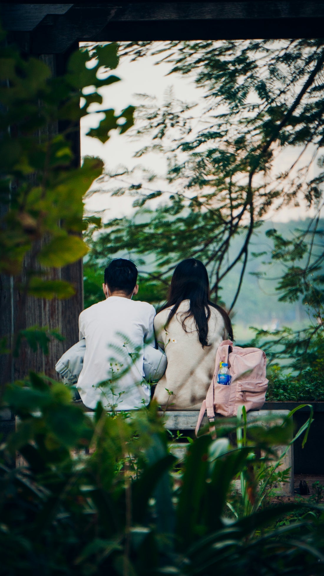 a man and a woman sitting on a bench