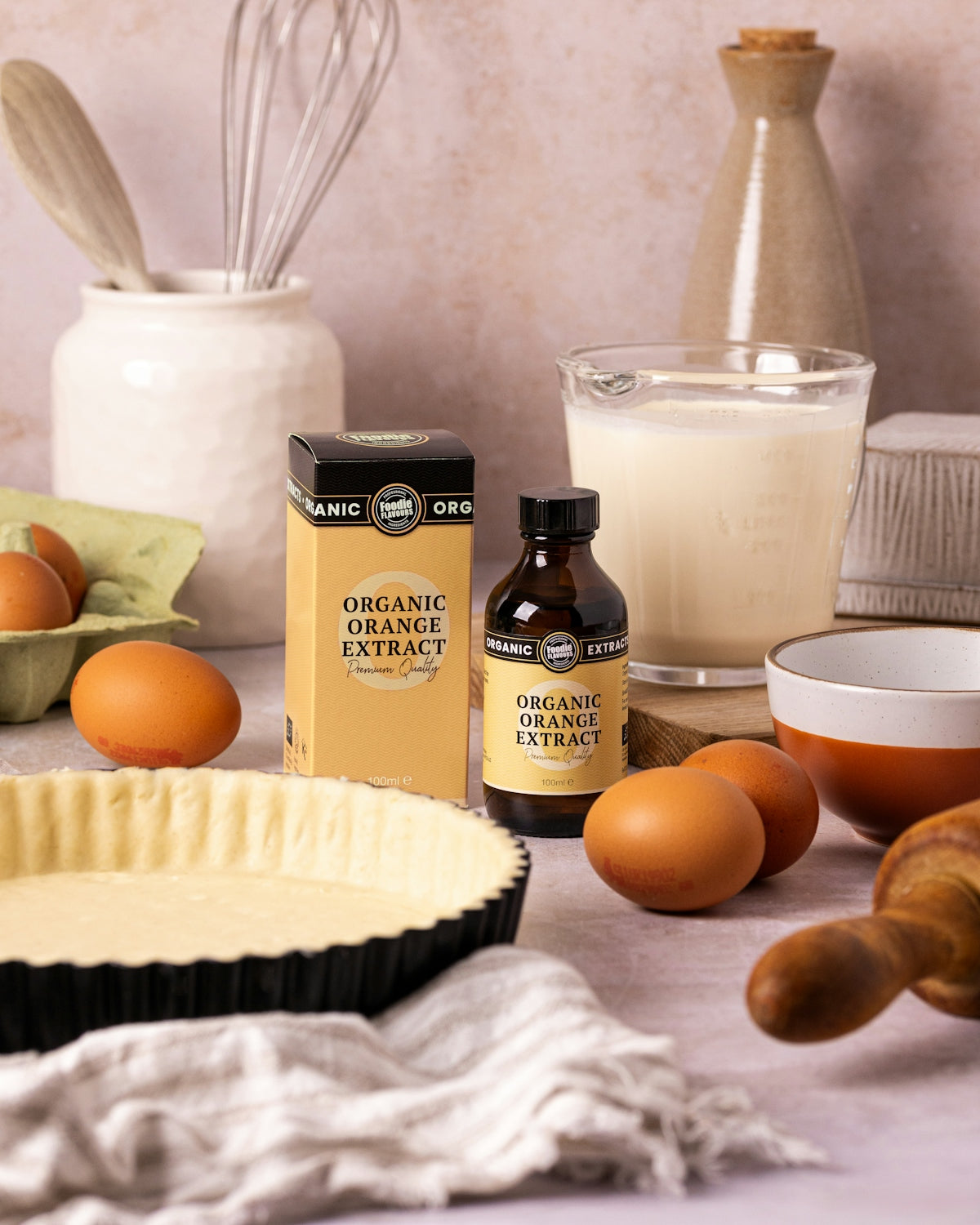 Baking ingredients including eggs, orange extract, and pie crust.