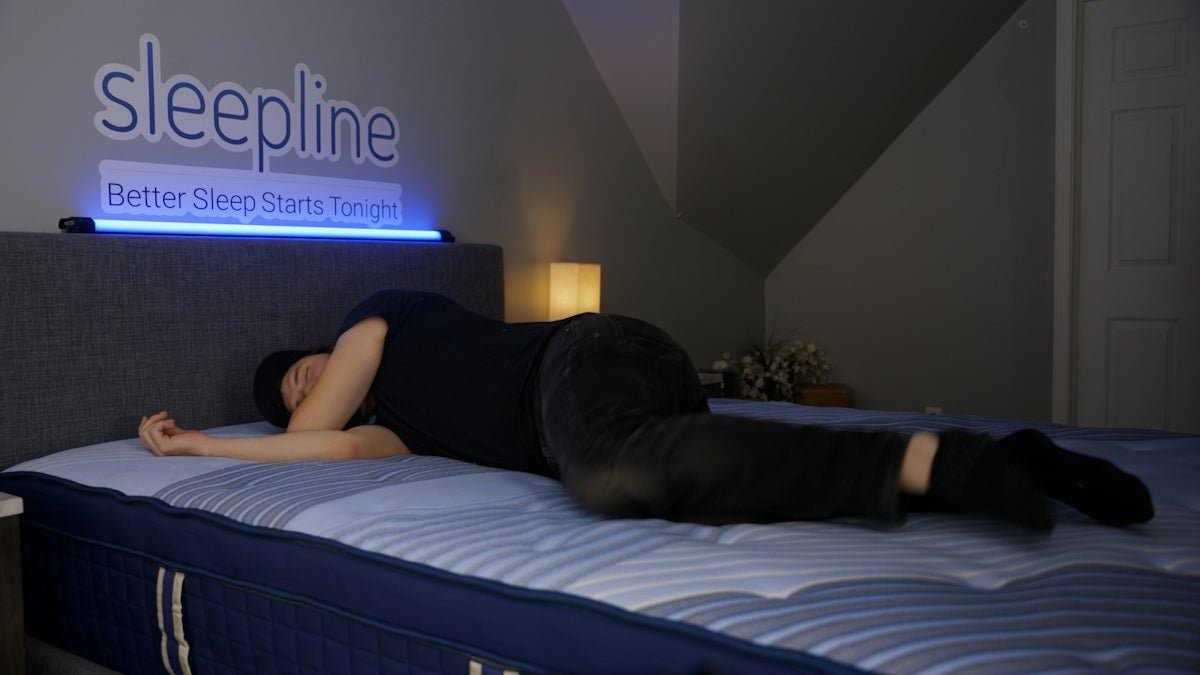 Person sleeping on their side on a mattress.